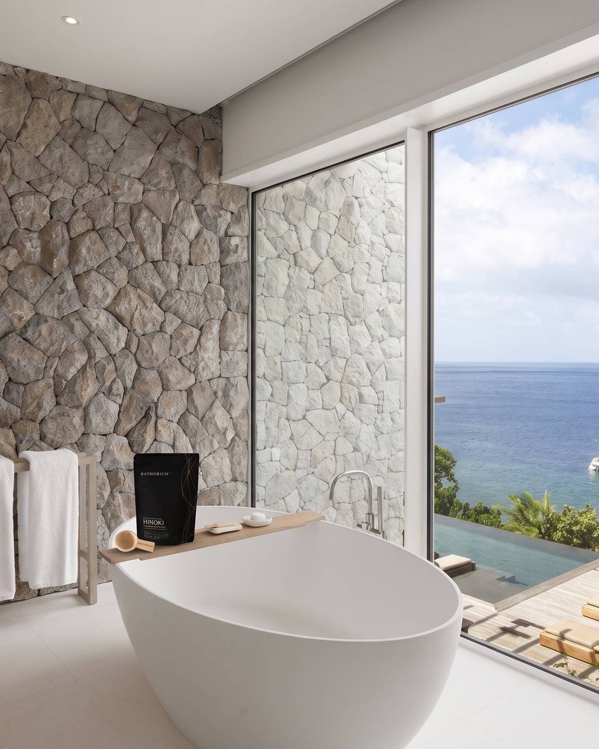 A Bathorium soak on the edge of a freestanding bath at Sugar Beach looking out to the sea