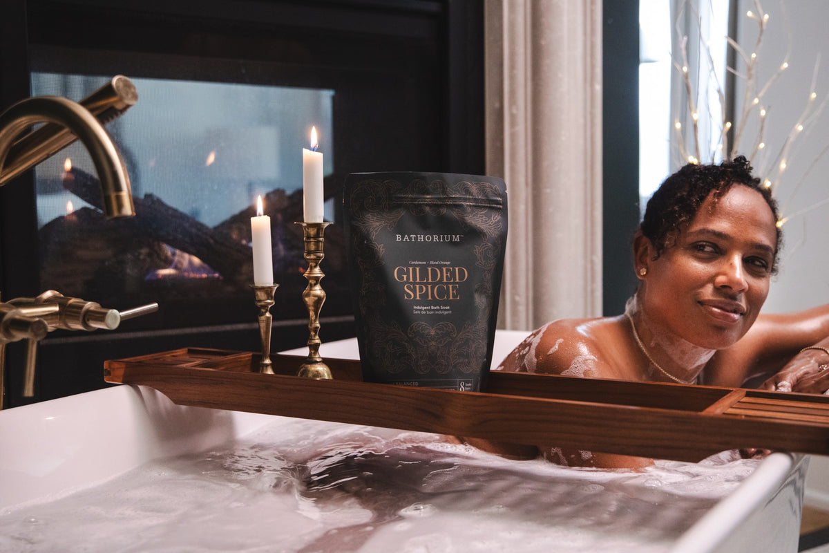 A fireside soak with the Gilded Spice pouch and candles on the bath tray