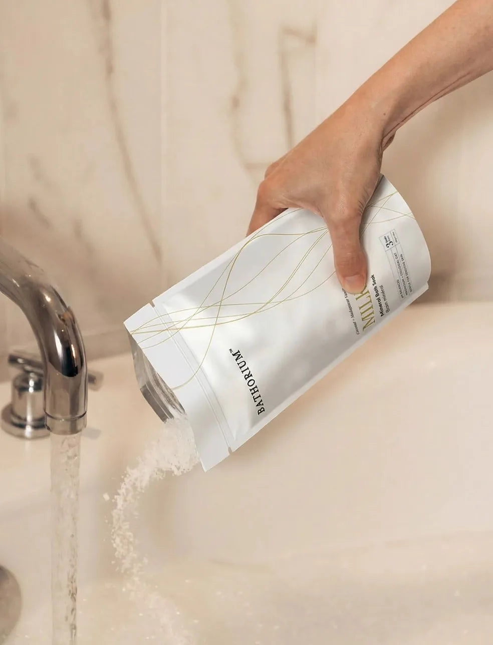 Milk Mineral Bath Soak poured into a running bath
