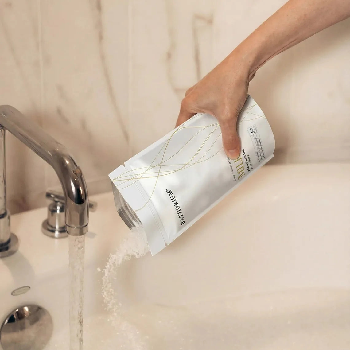 Milk Mineral Bath Soak poured into a running bath