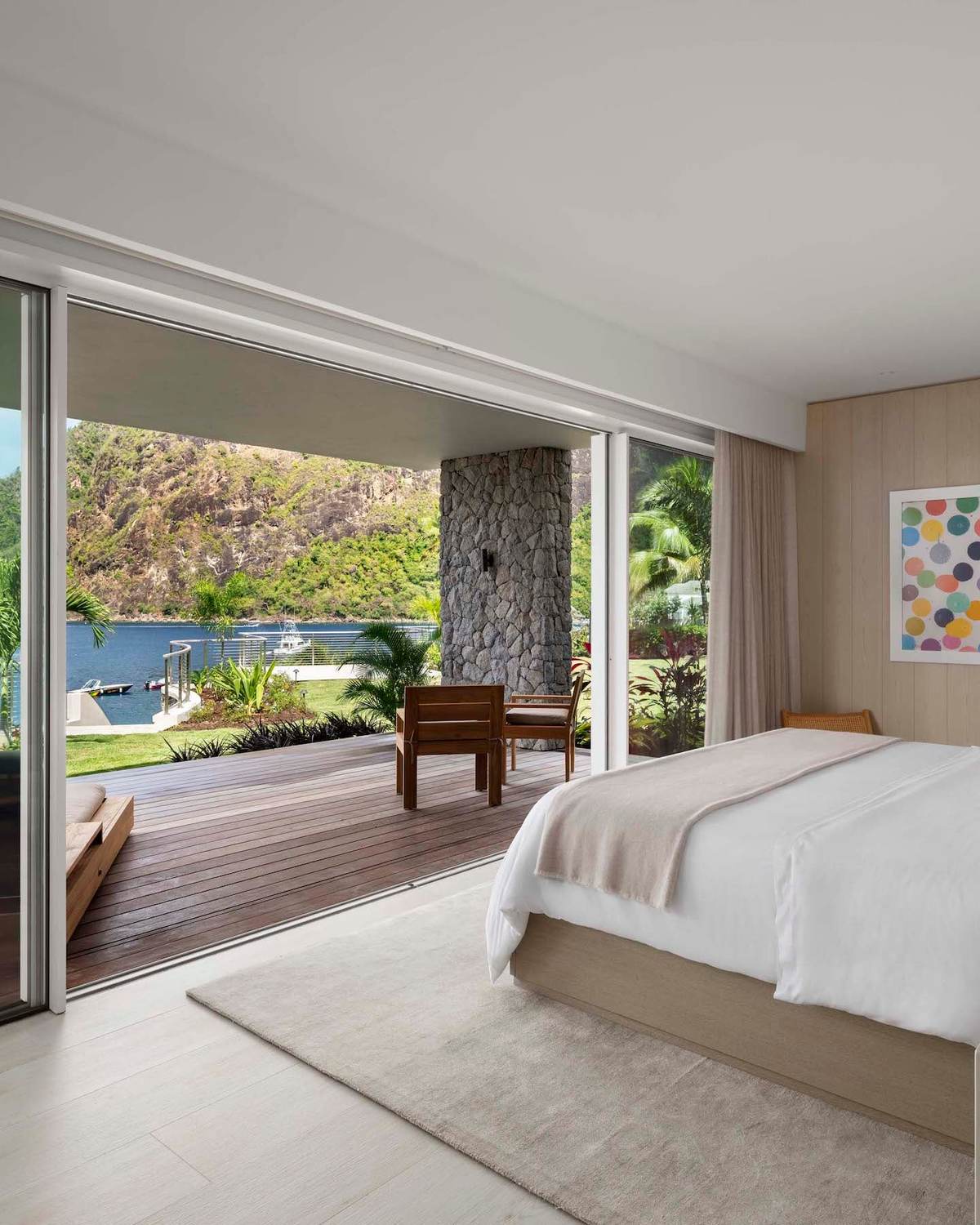 A villa bedroom at Sugar Beach opening on to the deck and a Piton