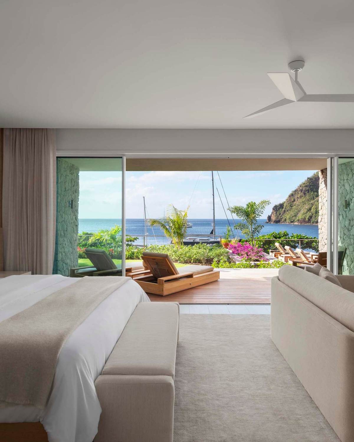 A bedroom at Sugar Beach opening on to a private deck above the water